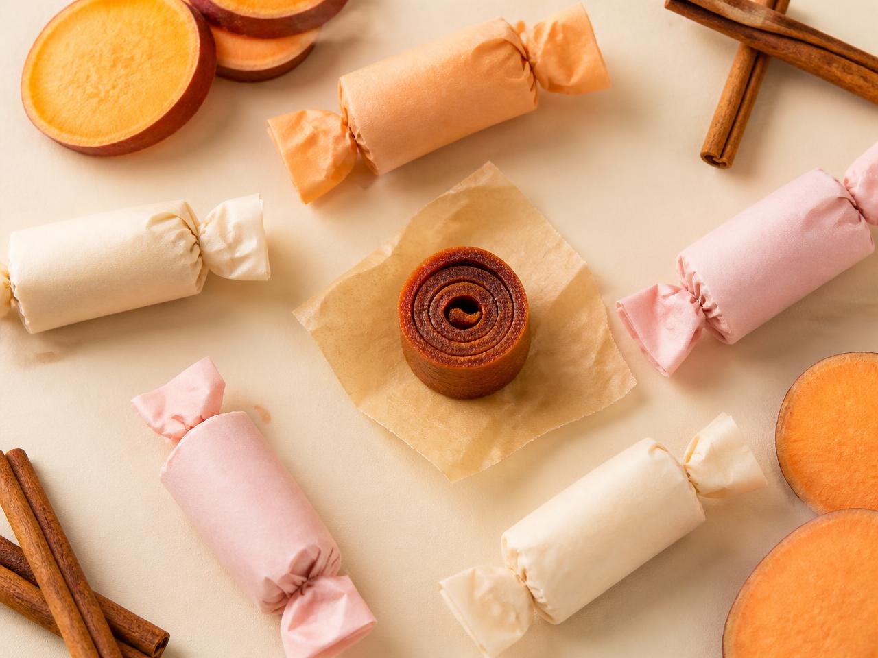 Wrapped rolled sweet potato candy bites with sweet potato slices and cinnamon sticks